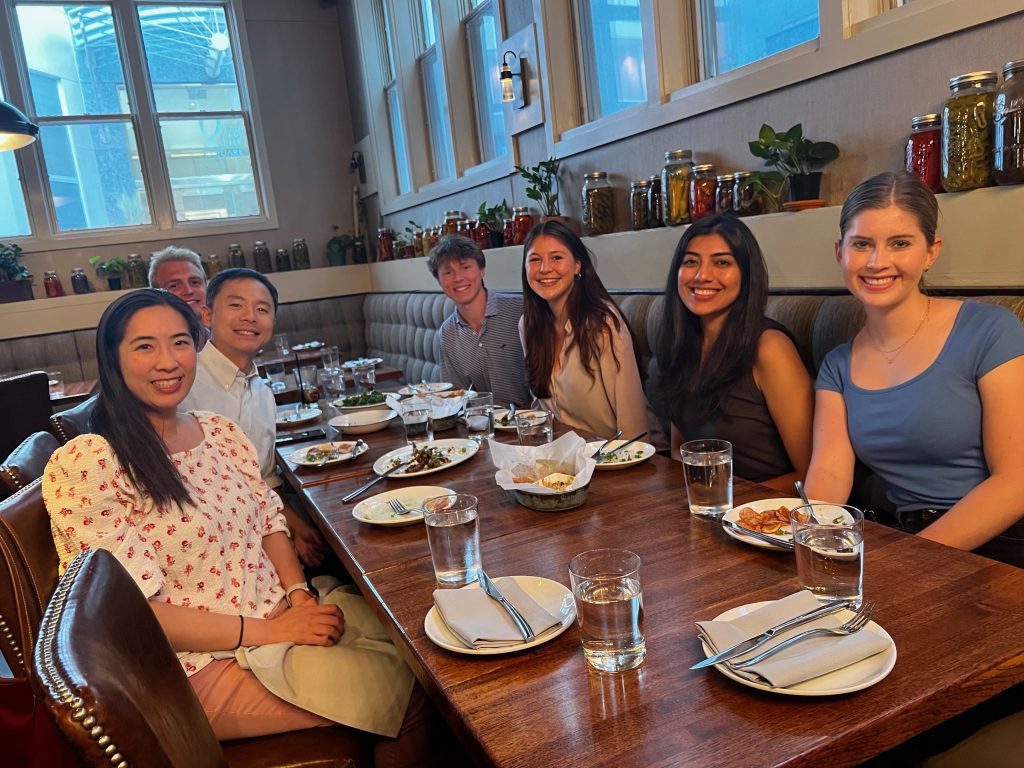 Student team sitting down at dinner table